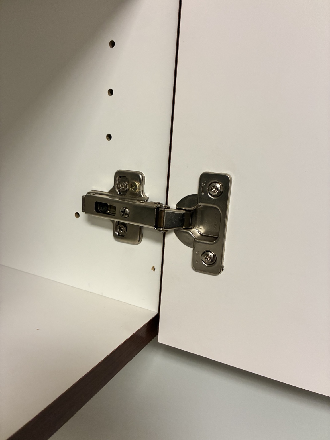 Close view of a concealed European-style cabinet hinge