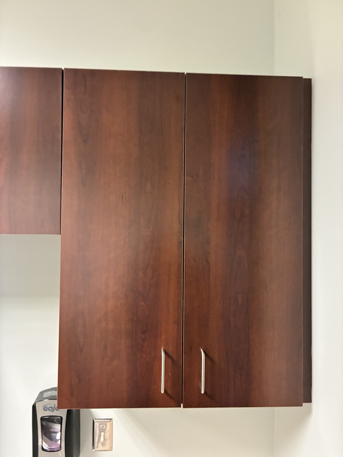 Commercial wall cabinet with two doors slightly out of alignment