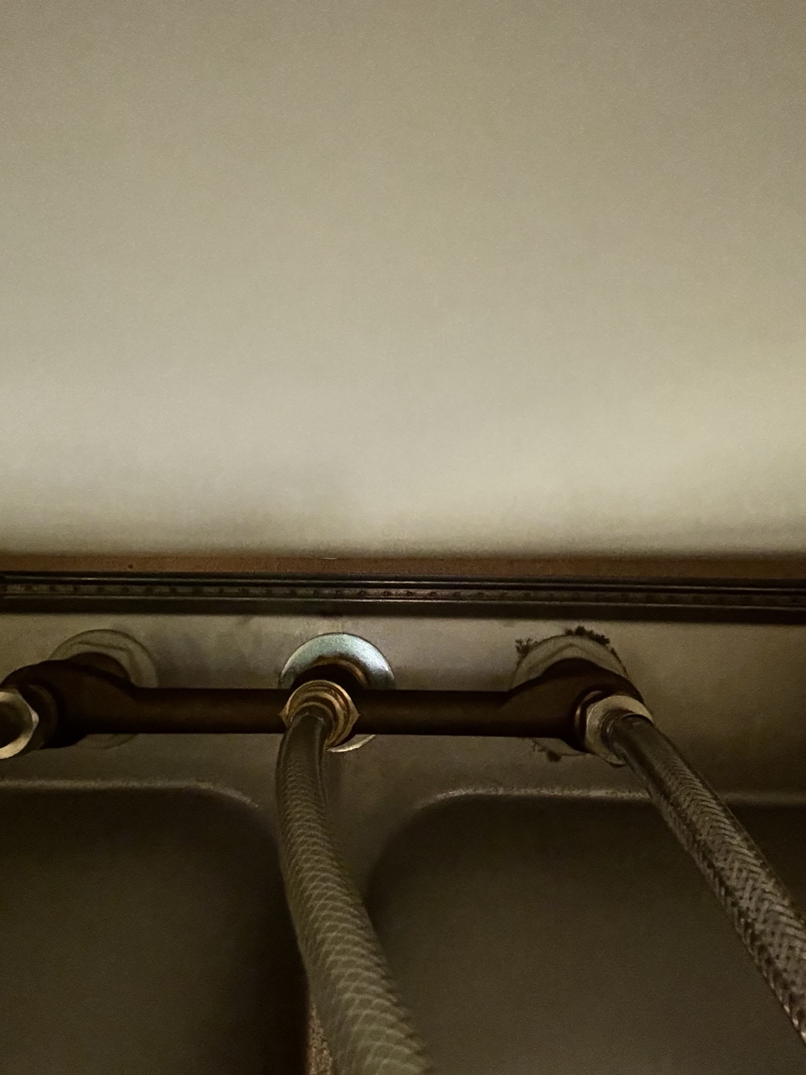Braided faucet supply lines under a sink