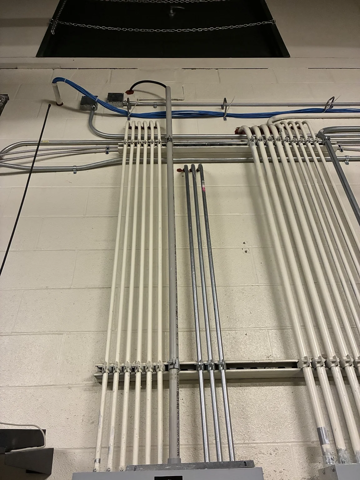 Instalación de panel eléctrico comercial con conducto que ingresa por encima del gabinete