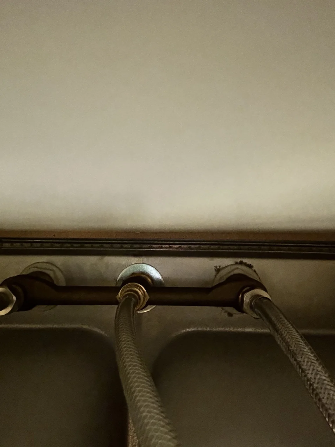 Braided faucet supply lines under a sink
